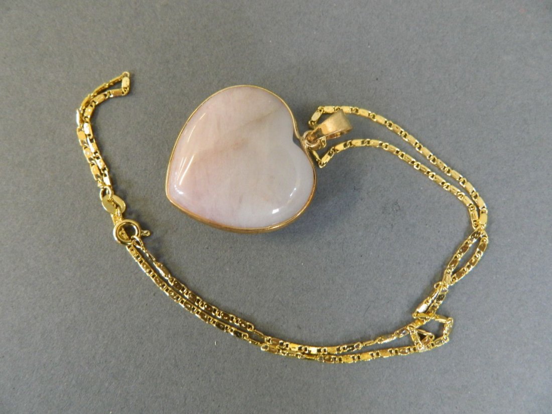 A heart shaped jade pendant on a gilt chain, 18" long: A heart shaped jade pendant on a gilt chain, 18" long