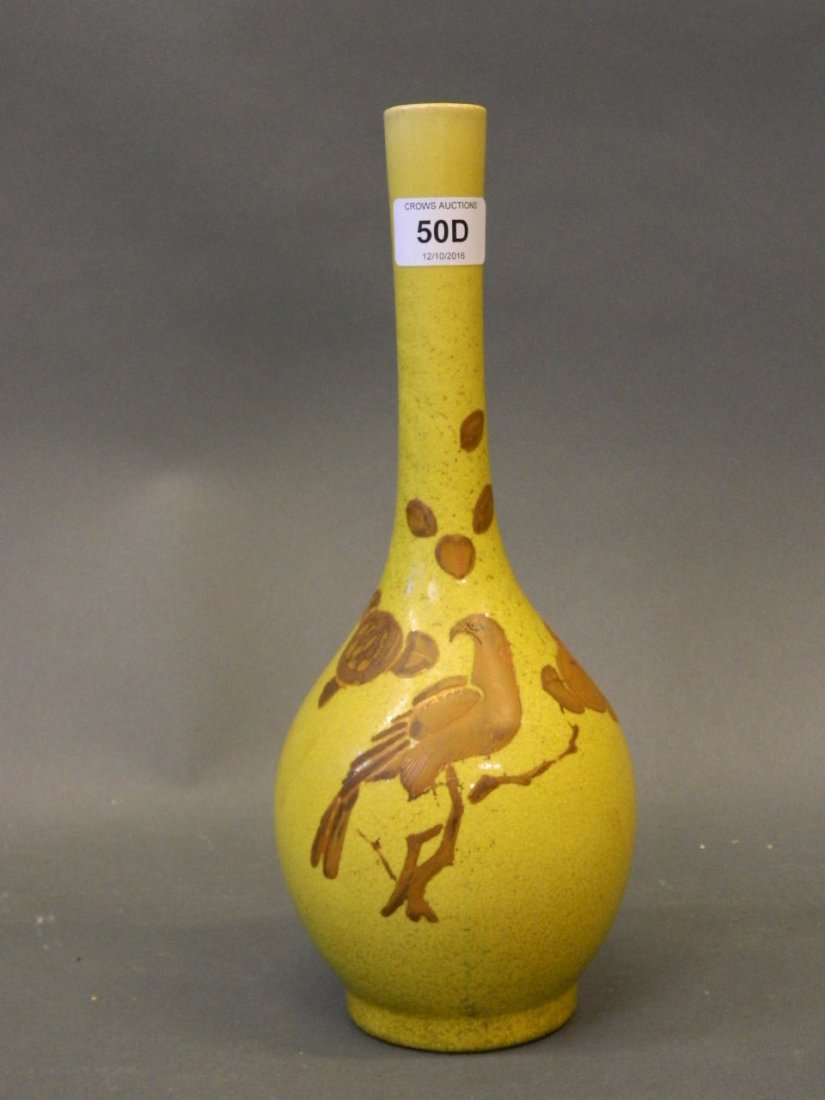 An Oriental yellow ground long necked vase with raised (1 of 2)