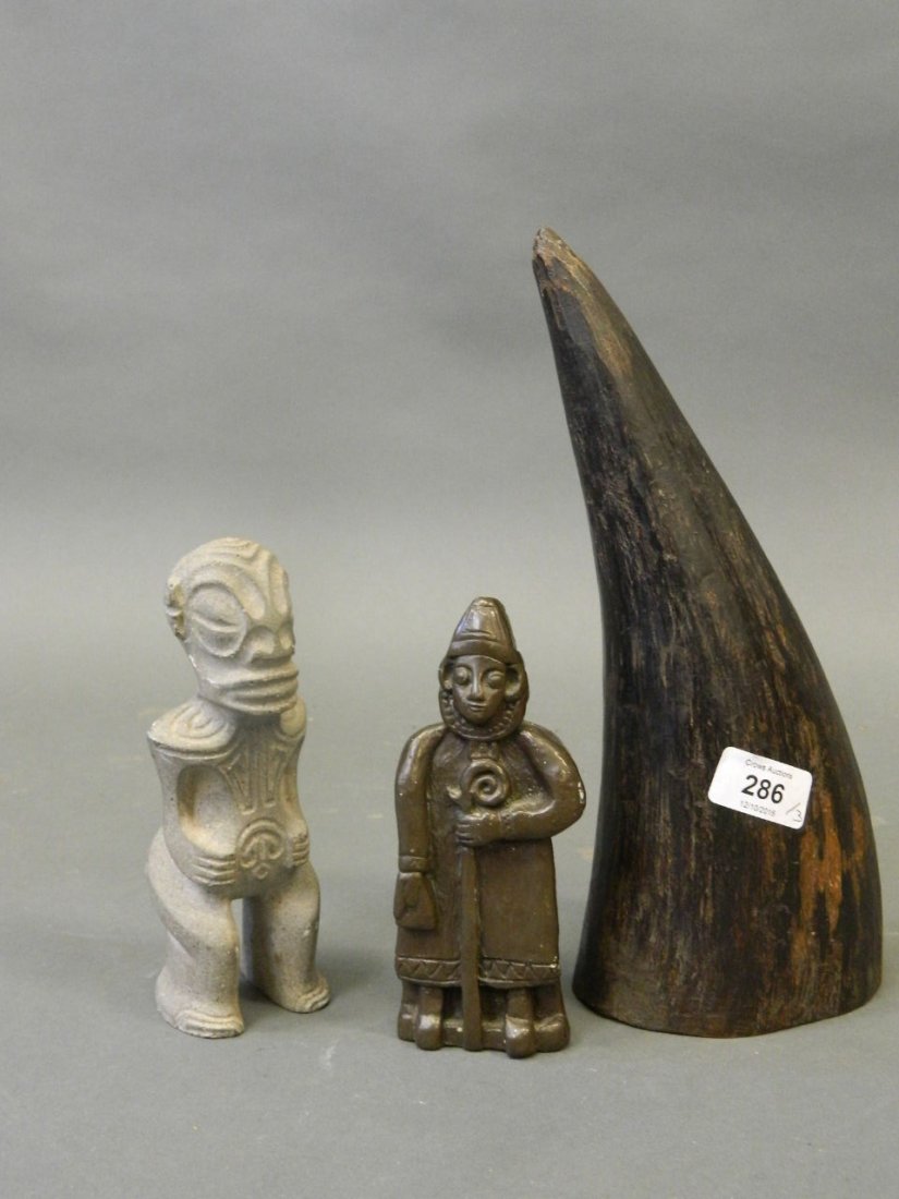An Eastern carved stone figure, together with a painted: An Eastern carved stone figure, together with a painted composition figure of a shepherd, and a buffalo horn