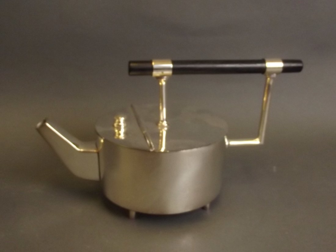 A Christopher Dresser style silver plated teapot with (1 of 2)