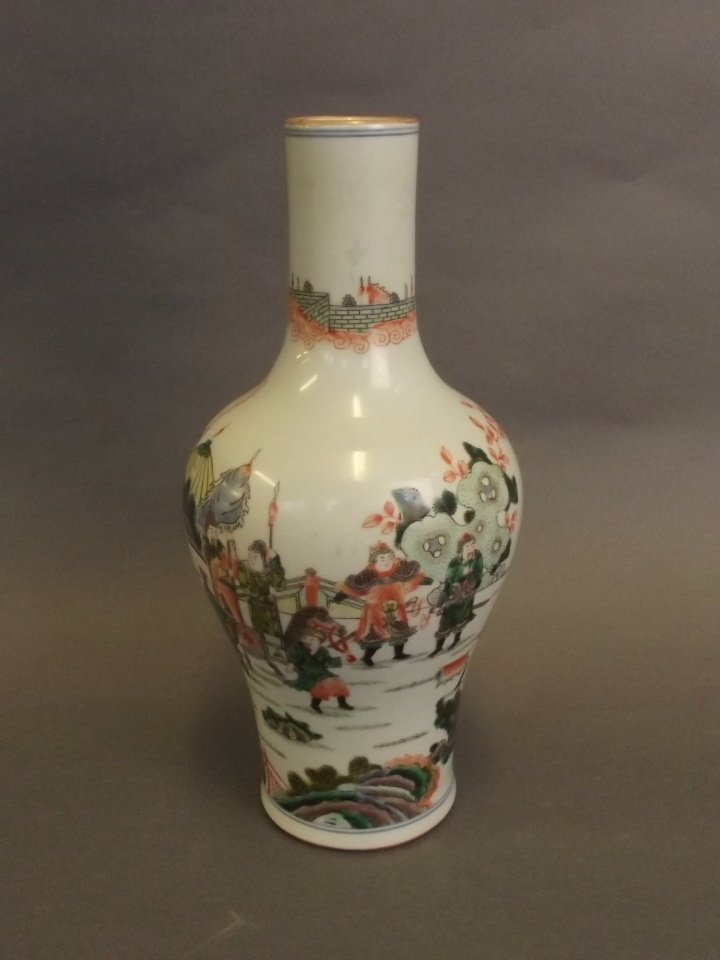 A Chinese famille verte enamel porcelain vase decorated: A Chinese famille verte enamel porcelain vase decorated with warriors in training, 6 character mark to base, 11½" high