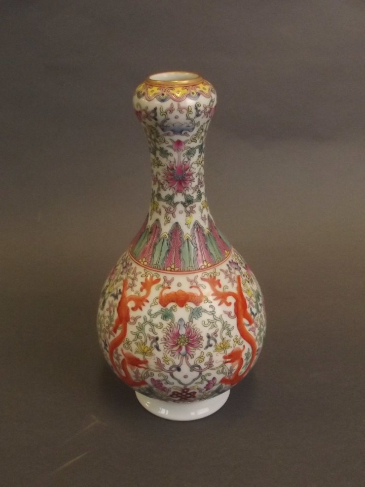 A Chinese polychrome enamelled porcelain vase with: A Chinese polychrome enamelled porcelain vase with scrolling dragon and lotus flower decoration, seal mark to base, 8½" high