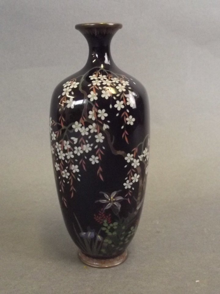 A small Japanese wireless cloisonné vase decorated with: A small Japanese wireless cloisonné vase decorated with a flowering tree on a black ground, 5" high (AF)