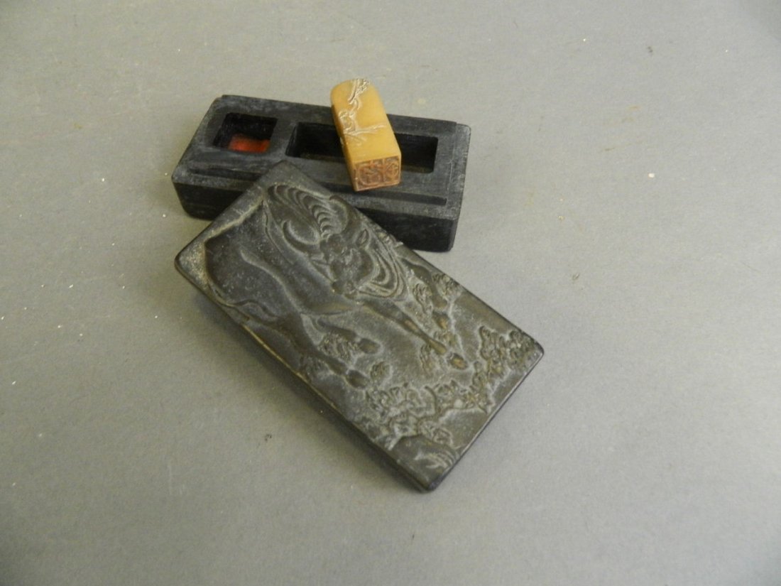 A Chinese ebonised wood box with carved buffalo: A Chinese ebonised wood box with carved buffalo decoration to lid, containing an amber soapstone seal and ink blot, seal mark to base, 2" x 4"