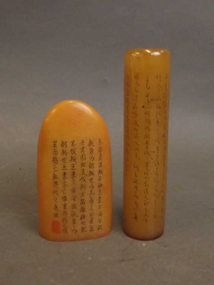 A Chinese cylindrical amber soapstone seal with: A Chinese cylindrical amber soapstone seal with inscription, and another similar, largest 3_"
