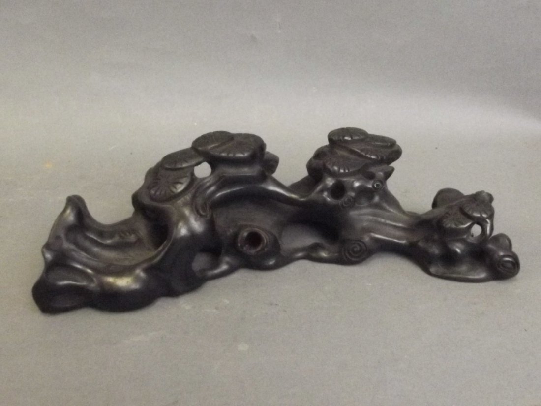 A Chinese carved and pierced ebonised wood brush rest: A Chinese carved and pierced ebonised wood brush rest in the form of a cypress tree, 8" long