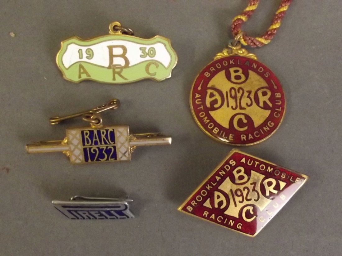 A Brooklands Automobile Racing Club 1923 enamel badge,: A Brooklands Automobile Racing Club 1923 enamel badge, no. 784, and another similar, no. 439, impressed maker's mark 'W.O. Lewis, Birmingham', an enamel badge, no. 90 from 1930, another no. 755 from 1