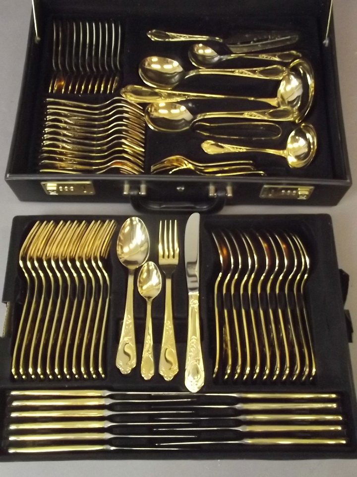 A Solingen twelve place gilt plated cutlery service, in (1 of 2)