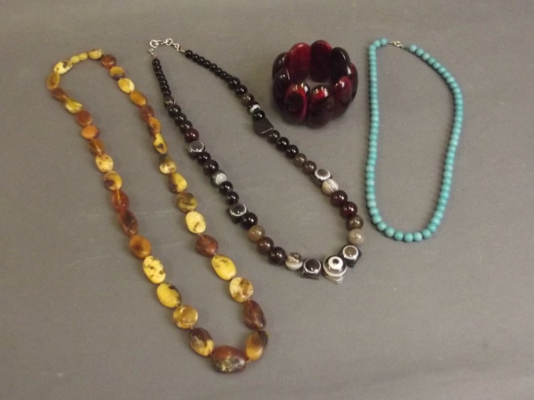 A horn bead bangle, a graduated string of natural amber (1 of 5)