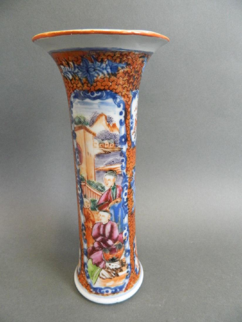 A Cantonese vase with flared rim and decorated with: A Cantonese vase with flared rim and decorated with panels of figures in a garden in bright enamels, 8" high