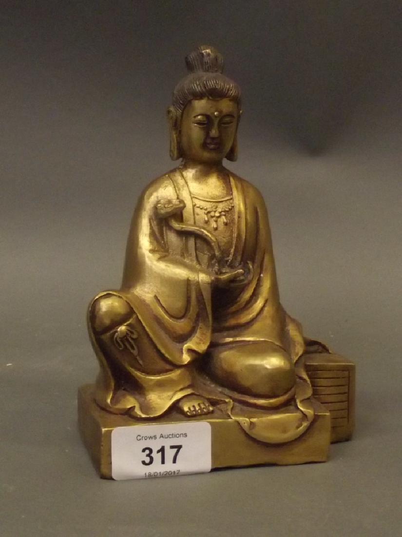 A Chinese brass figure of Quan Yin seated with a ruyi,: A Chinese brass figure of Quan Yin seated with a ruyi, 6½" high
