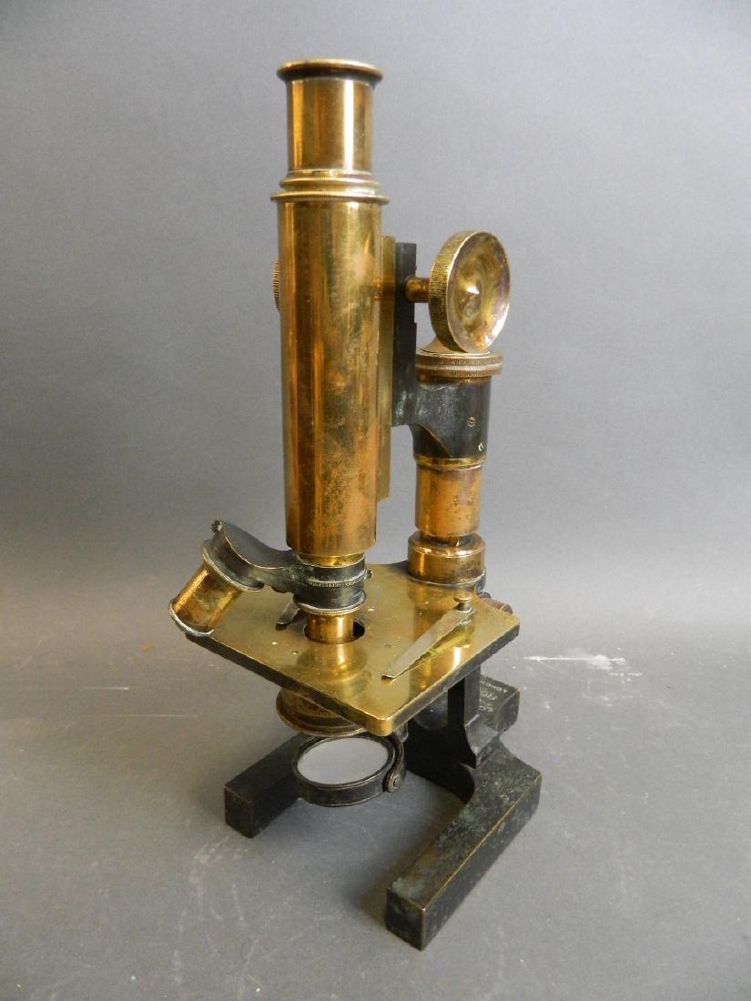 A C19th 'Eclipse' microscope no. 6184, of brass: A C19th 'Eclipse' microscope no. 6184, of brass construction, on a cast iron base, in original wood box, this instrument was once the property of Bernard Elmhirst Esq, Plymouth, the inside of the box