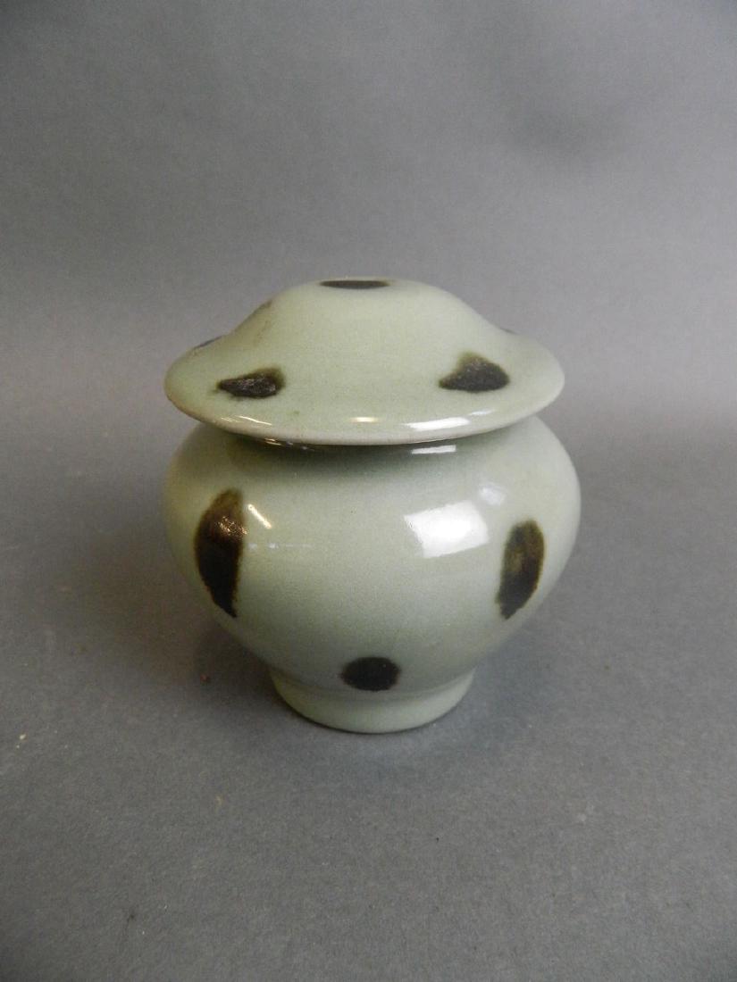 A small Chinese celadon glazed pot and cover with black (1 of 2)