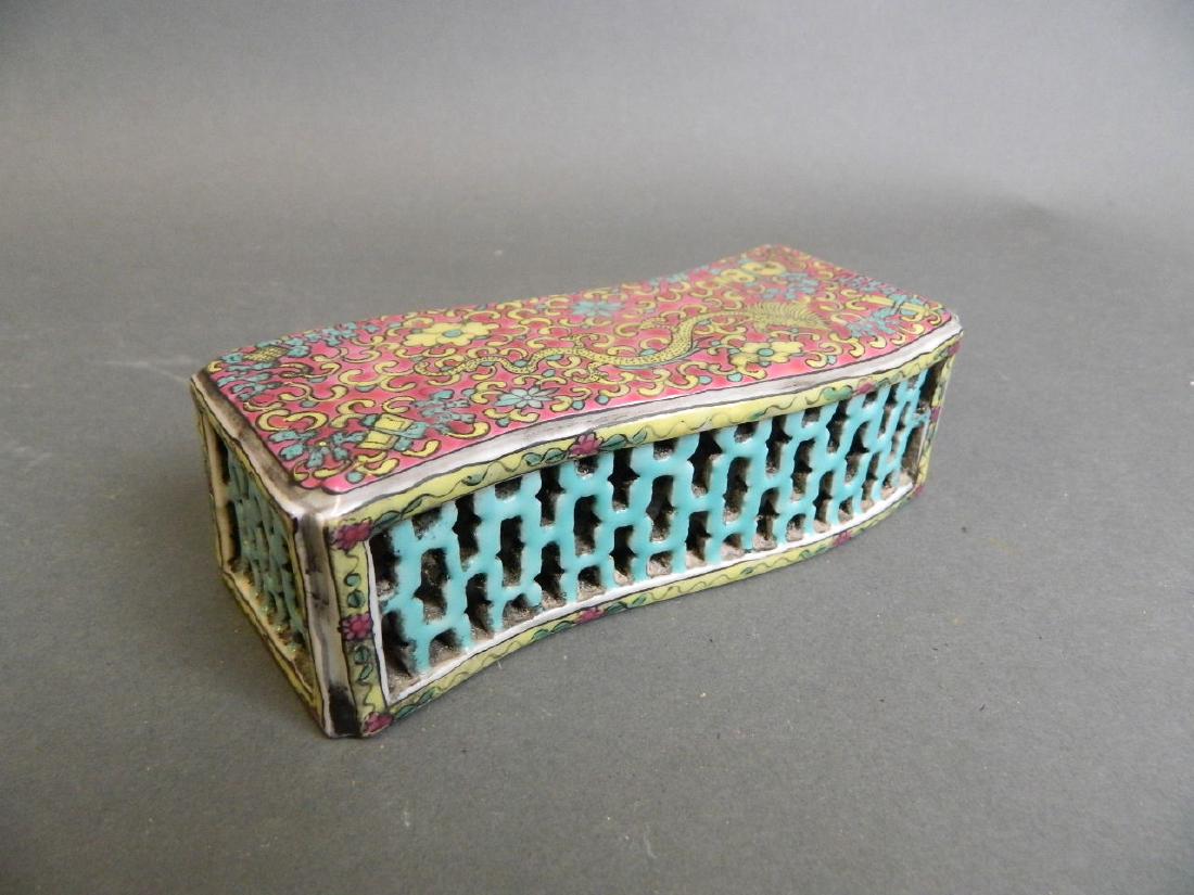 A Chinese famille rose enamel porcelain wrist rest with: A Chinese famille rose enamel porcelain wrist rest with pierced edges and dragon decoration, seal mark to base, 5" x 2"