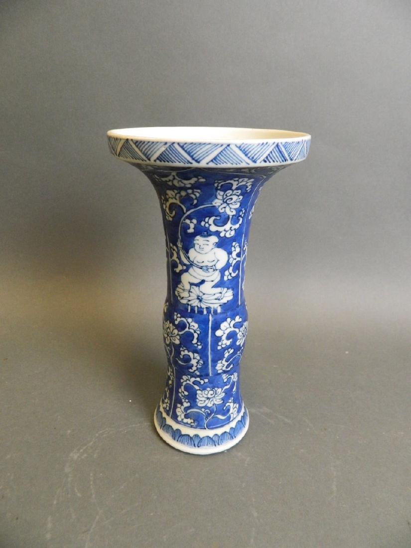 A Chinese blue and white porcelain Gu shaped vase with: A Chinese blue and white porcelain Gu shaped vase with painted decoration of young boys and lotus flower, 8" high
