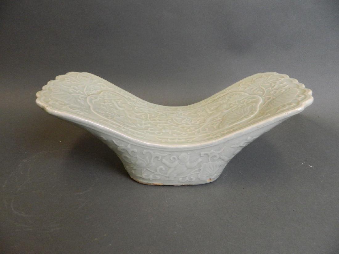 A Chinese celadon glazed pottery pillow with relief (1 of 3)