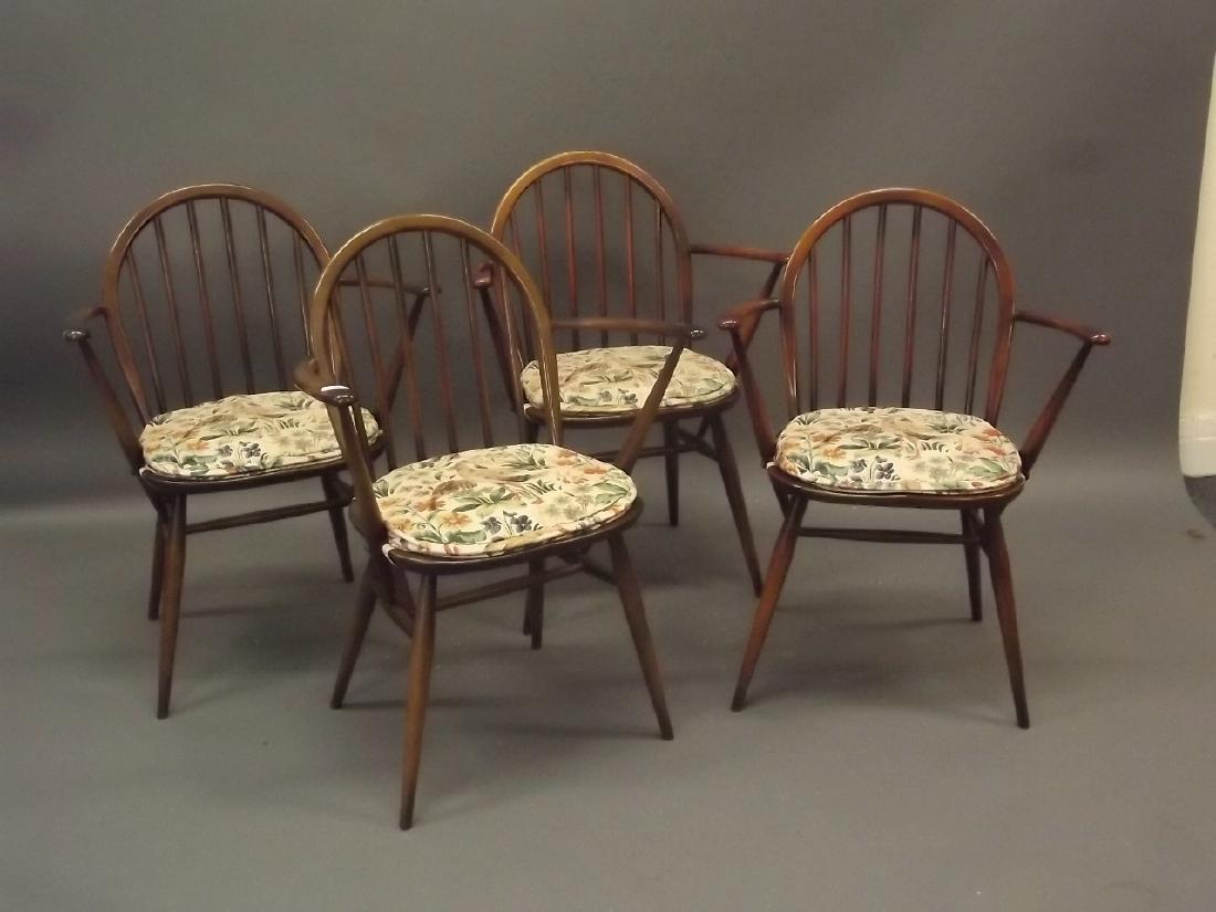 A set of four Ercol hoop backed elbow chairs: A set of four Ercol hoop backed elbow chairs