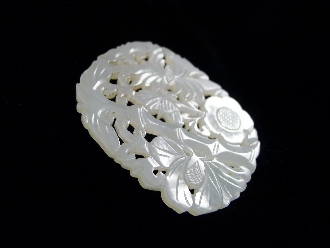 A VINTAGE CHINESE WHITE JADE HOLLOW SCULPTURE PLAQUE: A Vintage Chinese White Jade Hollow Sculpture plaque, flower, bamboo and ruyi design, shiny sparkling, moist feeling, the implication of gorgeous, feel warm, noble with the distinctive elegant taste.
