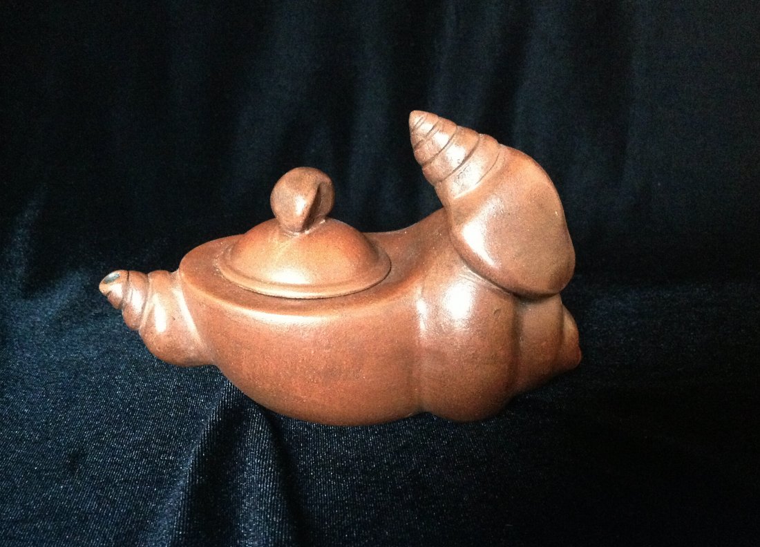 CHINESE YIXING CLAY TEAPOT: Chinese Yixing Clay Teapot with conch shape desgin, and seal mark on the bottom, 11 cm x 16 cm.