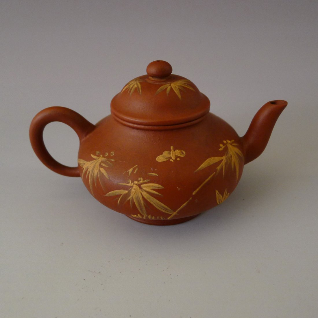 CHINESE YIXING CLAY TEAPOT: 中國宜興紫砂茶壺 Chinese Yixing Clay Teapot with bamboo design, and a seal mark on the bottom, 4.3" x 3.0" x 2.6" (11 cm x 7.5 cm x 6.5 cm).