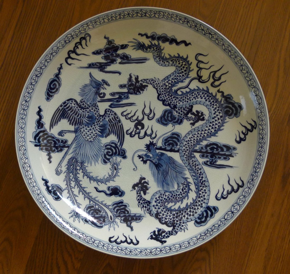 CHINESE BLUE AND WHITE BIG PLATE DECORATION: Chinese white and blue porcelain big plate, decorated with dragon and phoenix, there is seal mark on the back. Size: 16.8" (42.6 cm) diameter, 2.7" (7 cm) height, weight: 4,335 g.