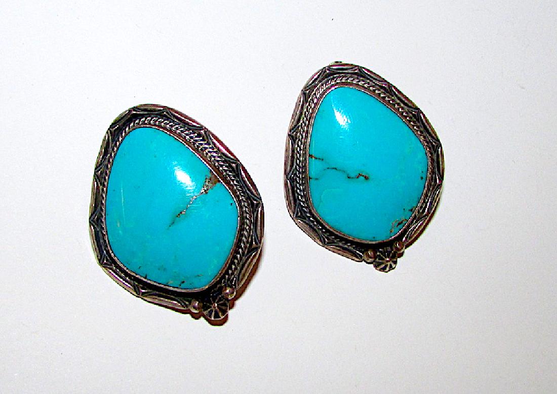 Navajo Sterling Turquoise Large Clip On Earrings by: Navajo Sterling Turquoise Large Clip On Earrings by Roie Jacque. Stunning, high quality large turquoise cabochons, signed by the artist and marked sterling. Highly collectible artist. Measure 1 5/8" b