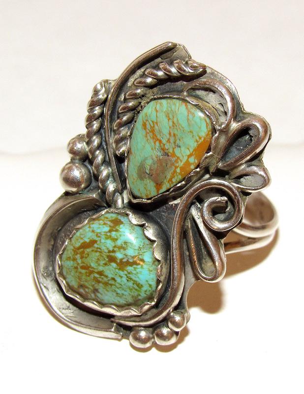 Navajo Elizabeth Platero Sterling King Manassa: Navajo Elizabeth Platero Sterling King Manassa Turquoise Ring Sz. 13 Squash blossom design. 1.5" on the front. Singed, marked, tested.