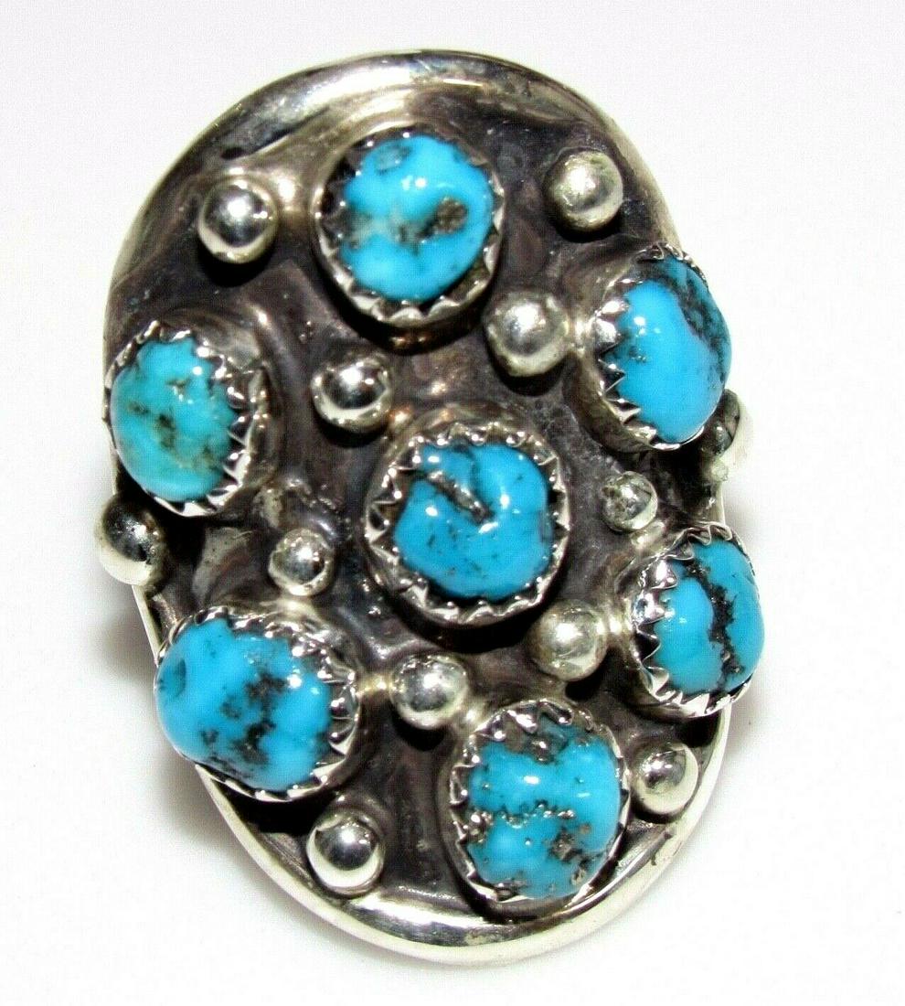 Navajo Turquoise Cluster Saddle Ring Size 7 Sterling: Fab Navajo sterling silver and Kingman turquoise cluster saddle ring in size 7. Marked "sterling" and is stamped with the artist's hallmark. Gorgeous stones, wonderful statement ring. Stunning example