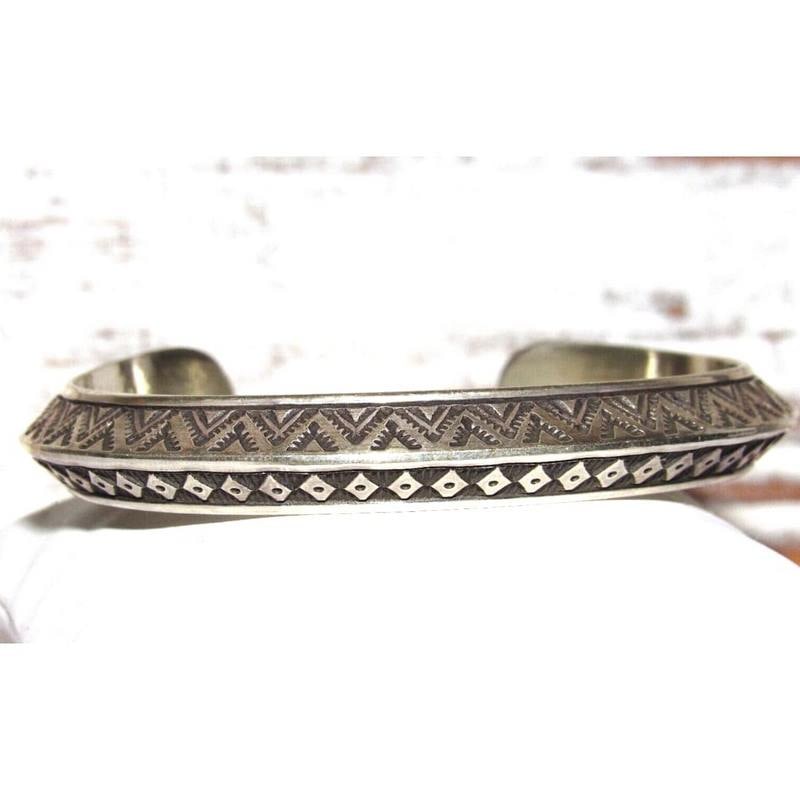 Navajo Sterling Carinated Ingot Double Sided Cuff Bracelet R Secatero: Phenomenal, substantial gauge sterling silver Native American Navajo intricately hand stamped, double sided cuff bracelet by the Navajo artist Randy Secatero.Exceptional craftsmanship and attention to