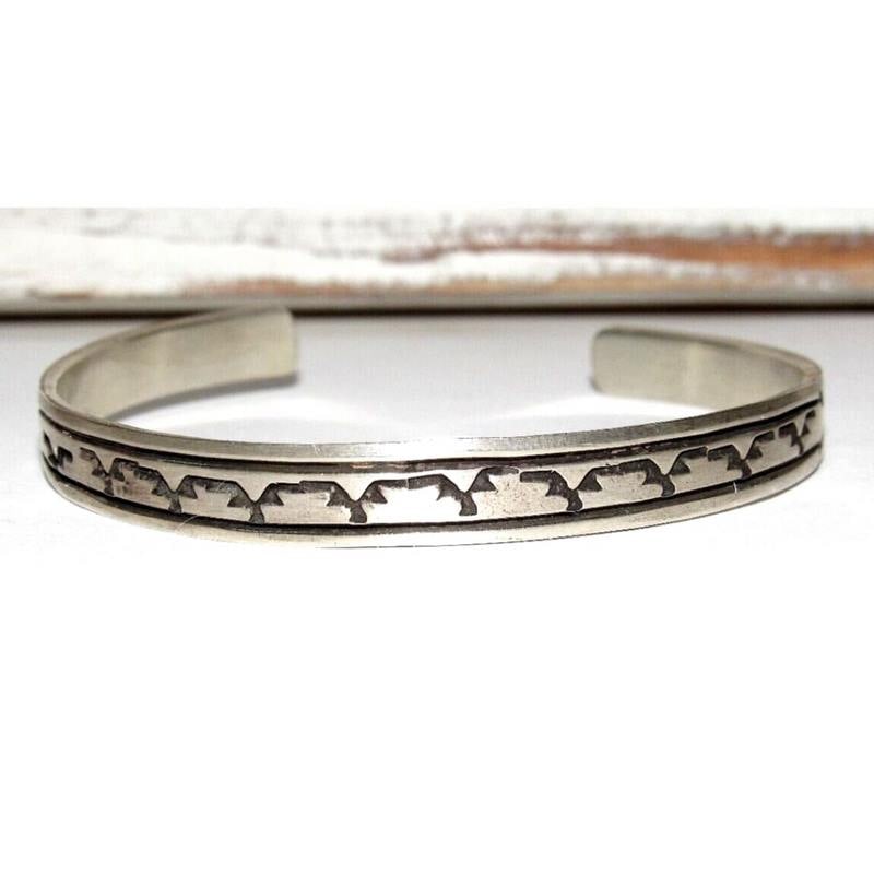 Navajo Sterling Silver Ingot Hand Stamped Stacker Cuff Bracelet R. Enriquez: Wonderful Navajo sterling silver hand stamped ingot tribal design stacker cuff bracelet by the Navajo artist R. Enriquez. The cuff measures about 1/4" wide and the inside circumference is about 6 1/2"