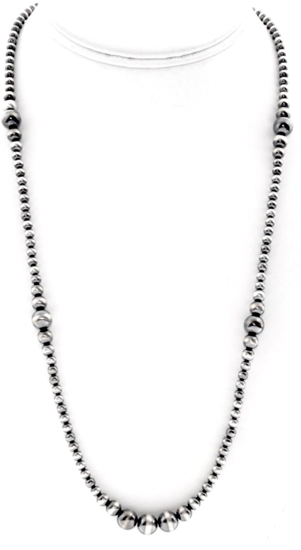 Navajo Pearls Necklace Sterling Silver Graduated Bead Design: Navajo Pearls Necklace Sterling Silver Graduated Bead Design. Graduated Navajo pearls beads measure 4mm, 5mm, 6mm and 8mm. The necklace is about 24" long. Traditional hook & eye closure. FREE SHIPPING