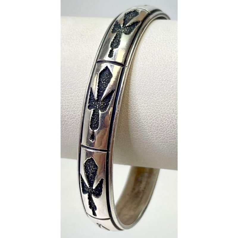 Vintage Navajo Tommy Singer Sterling Silver Stacker Cuff Bracelet: Rare vintage sterling silver bracelet by renowned Navajo artist Tommy Singer, featuring his iconic peyote bird design. The bold, raised and oxidized motif stands out against a high-polish silver surfa