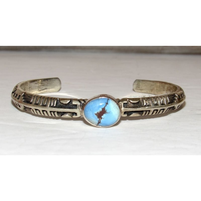 Native American Navajo Golden Hills Turquoise Sterling Bracelet B. Short: Discover the elegance of the Navajo Golden Hills turquoise sterling bracelet. This handcrafted piece displays a rare Golden Hills turquoise stone. Its sterling silver band features unique hand-stamped