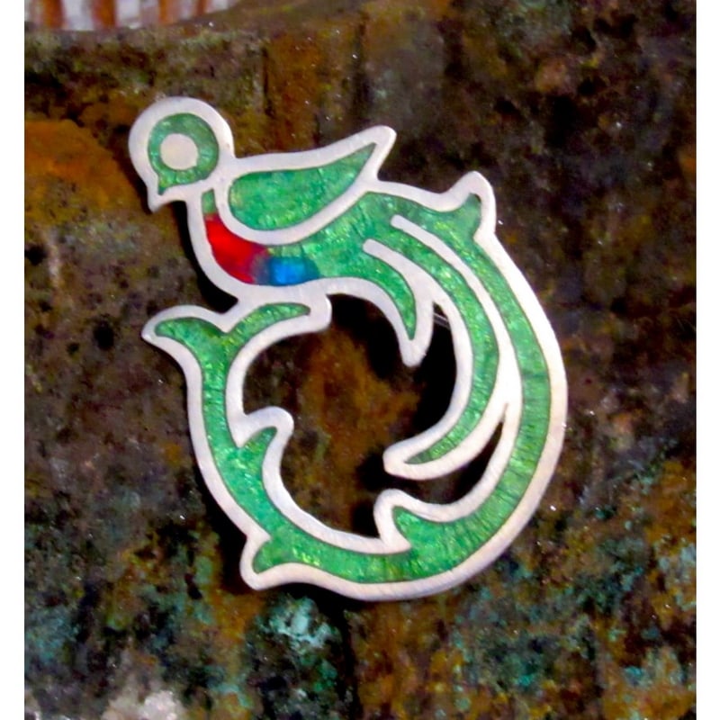 Vintage Taxco Mexico Sterling Silver Bird of Paradise Brooch Pin Pendant: This Taxco sterling silver Bird of Paradise brooch pin pendant features vibrant green enamel with red and blue accents in a flowing stylized bird design. Crafted in sterling silver, the openwork form