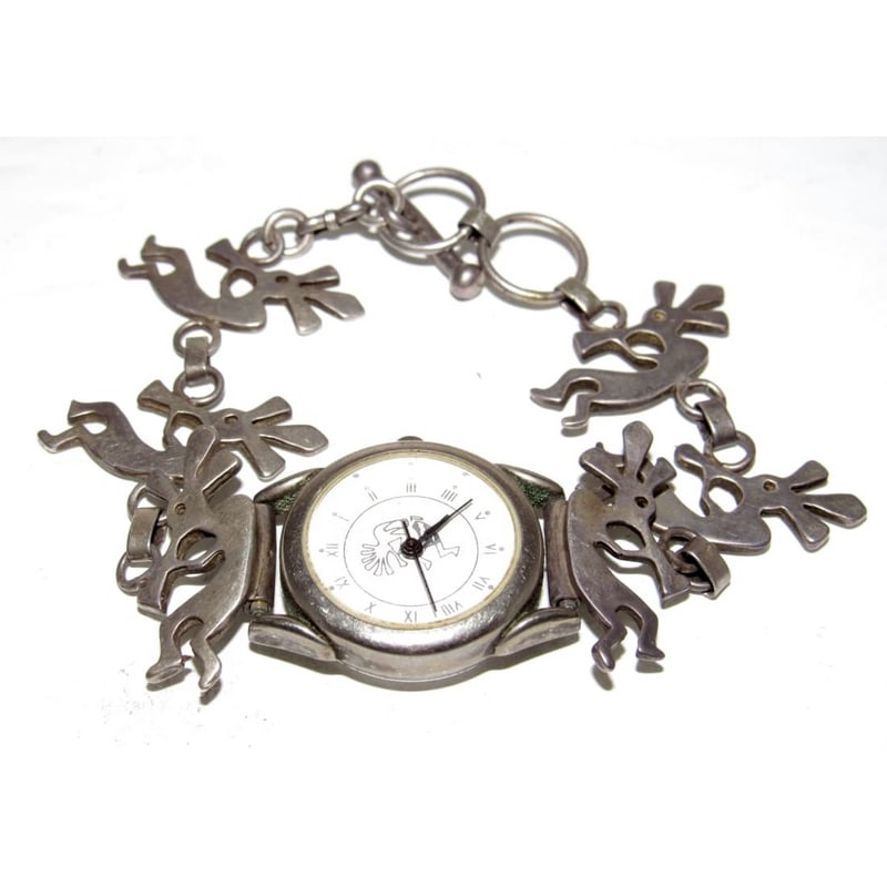 Vintage Navajo Sterling Silver Kokopelli Watch – Southwest Native American Design: Vintage Navajo sterling silver watch featuring a linked bracelet design with repeating Kokopelli figures, a well-known symbol in Southwestern and Native American art representing fertility, joy, music