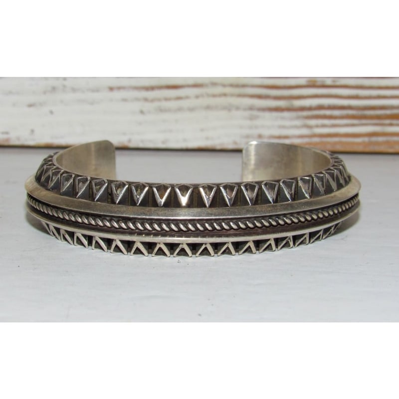 Navajo Carinated Hand Stamped Ingot Double Sided Cuff Bracelet L. Tahe 7": Phenomenal, heavy gauge sterling silver Native American Navajo intricately stamped, double sided cuff bracelet by the Navajo artist L. Tahe. Exceptional craftsmanship and attention to detail, intricat