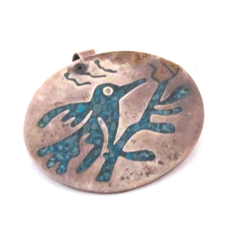 Vintage Taxco Mexican Silver Turquoise Inlay Bird Pendant: Vintage Taxco silver pendant featuring a stylized bird motif with turquoise mosaic inlay. The design reflects traditional Mesoamerican symbolism, where birds are associated with freedom, vision, and c