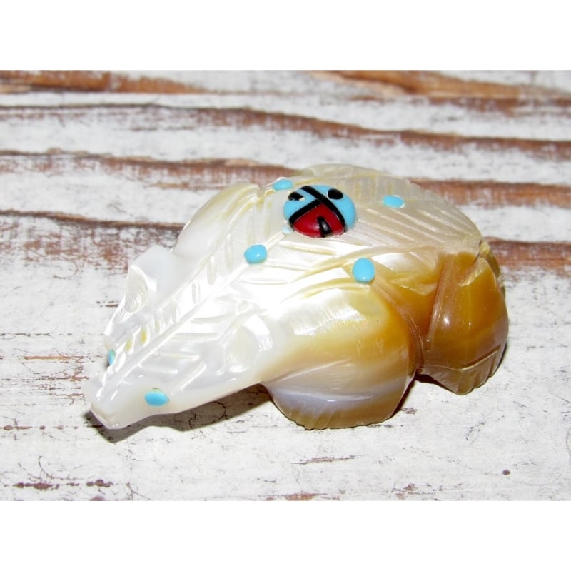 Zuni Badger Fetish – Mother of Pearl Shell with Turquoise Inlay: This Zuni badger fetish is hand-carved from luminous mother of pearl shell, showing natural creamy white tones with warm honey-brown variation, and is accented with turquoise dot inlay and a tradition