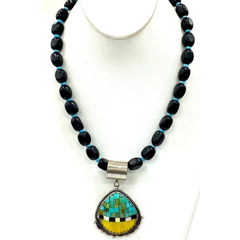 Joseph Tenorio Santo Domingo Onyx Necklace with Turquoise Pendant: Joseph Tenorio Santo Domingo Onyx Necklace with Turquoise Pendant. Discover the striking beauty of the Joseph Tenorio Santo Domingo onyx necklace. This one-of-a-kind piece is handcrafted by renowned N
