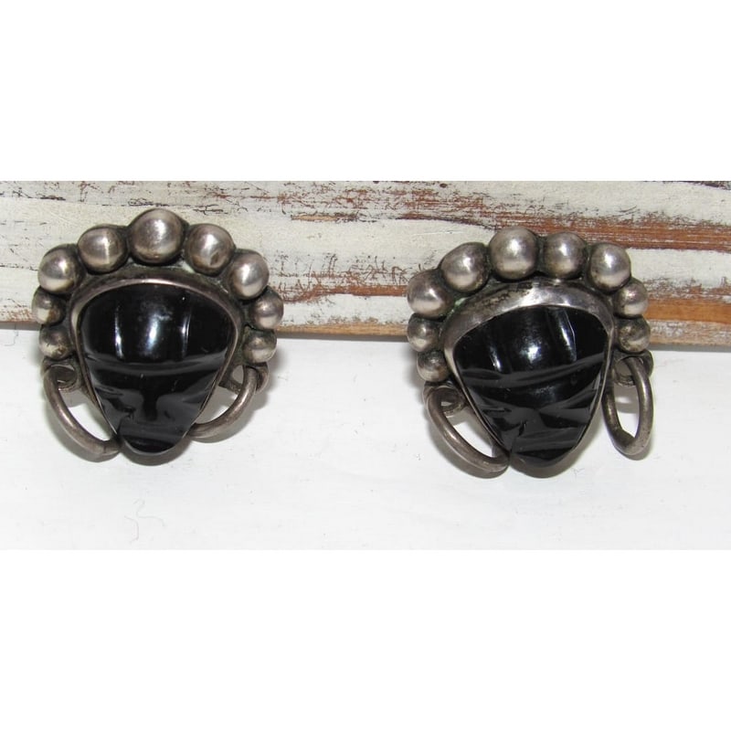 Early Taxco Mexico Pre-Eagle Sterling Silver & Onyx Earrings: These mid-century, pre-Eagle Taxco, Mexico sterling silver screw-back earrings are a powerful match to the bracelet, featuring the same pre-Columbian-inspired design with deeply carved black onyx cabo