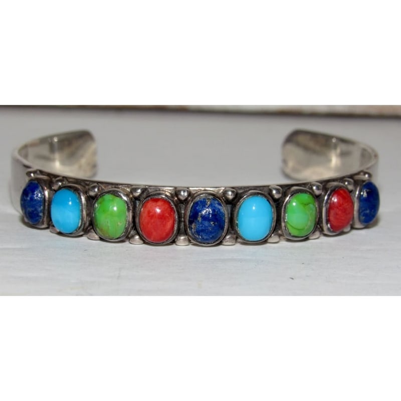 Vintage Navajo Turquoise Spiny Lapis Stacker Cuff Bracelet Sterling Silver: Vintage Navajo multi-stone cuff bracelet featuring a vibrant lineup of turquoise, gaspeite, lapis and spiny oyster cabochons set in sterling silver. The colorful stones are arranged in a clean, balanc