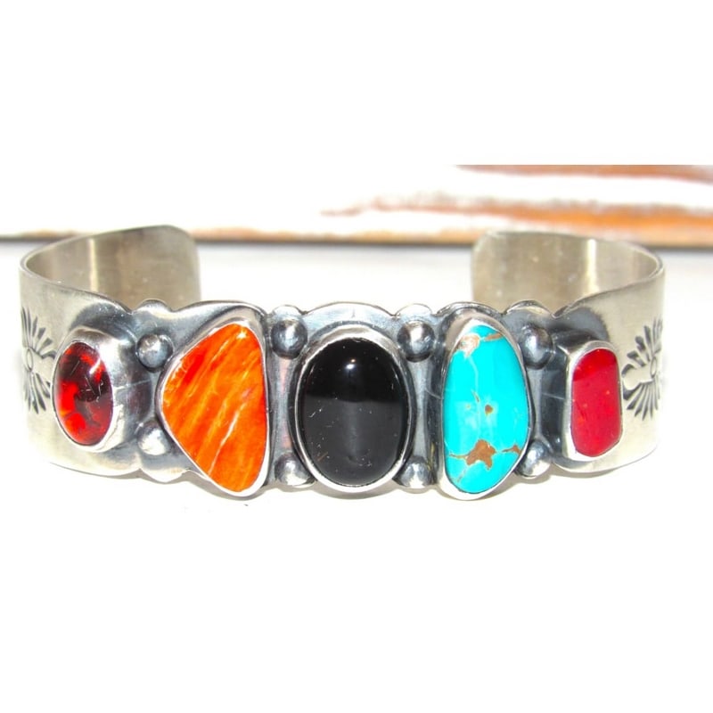 Navajo Sterling Silver Turquoise, Coral & Multi-Stone Cuff Bracelet J Begay: This stunning Navajo sterling silver cuff bracelet showcases a beautiful arrangement of five multi-color stones, including coral, Royston turquoise, black onyx, spiny oyster, and amber, each set in a 