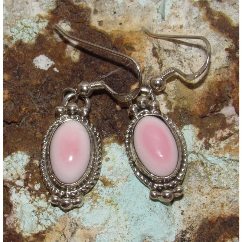Navajo Pink Conch Dangle Earrings Sterling Silver Signed: Navajo sterling silver earrings with a tear drop shape pink conch dangle by the navajo artist Marcela James. It measures about 1 1/4" long with sterling silver French wires. Weigh 6g total weight for 