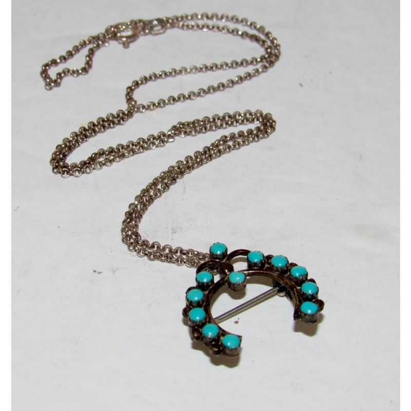 Old Pawn Zuni Snake Eye Turquoise Naja Pin Pendant Necklace: Old Pawn Zuni sterling silver snake eye turquoise naja pin/pendant on a sterling silver chain necklace. This vintage Zuni piece features classic snake eye turquoise stones set in a traditional naja fo