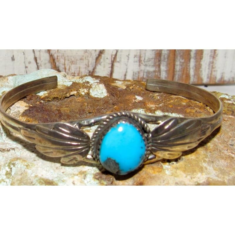 Navajo Turquoise Cuff Bracelet Sterling Silver Blossom Design: This wonderful Navajo sterling silver Sleeping Beauty turquoise bracelet features a vivid natural turquoise cabochon with visible matrix, set in a traditional squash blossom-inspired design accented b