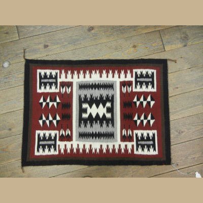 AUTHENTIC NAVAJO TIGHTLY WOVEN WOOL RUG: THIS AUTHENTIC NAVAJO RUG HAS A STORM PATTERN AND IS MADE OF 100% WOOL AND NAVAJO DYES. TIGHTLY WOVEN AND IN PERFECT SHAPE IN EVERY WAY. 31 1/2" X 23"