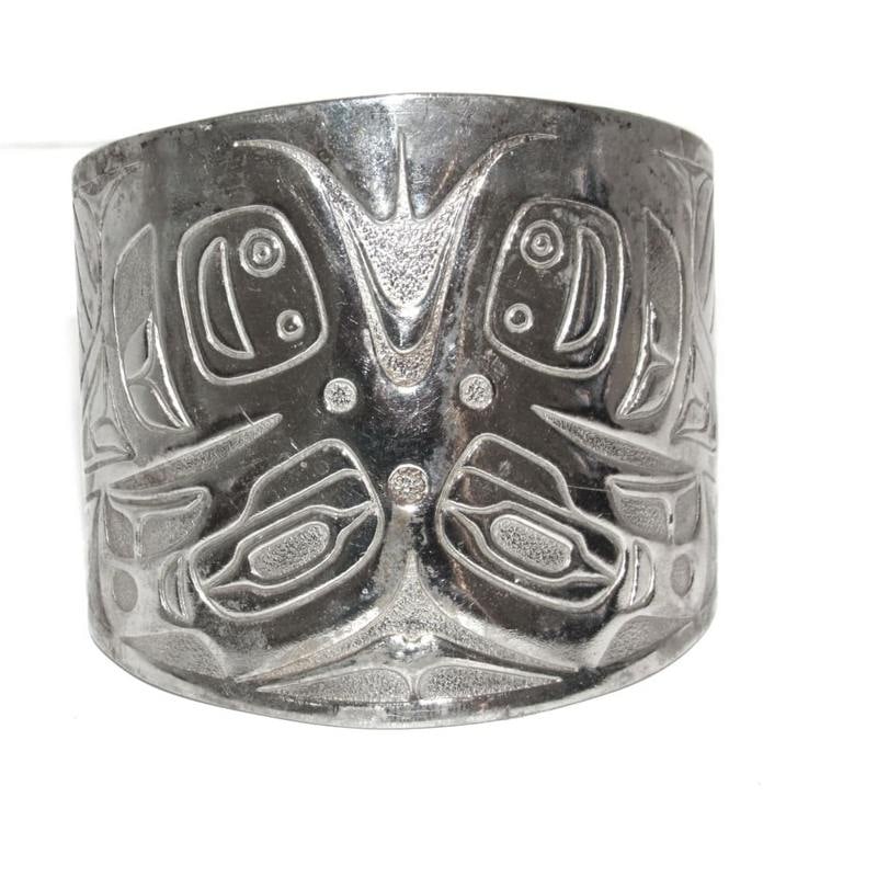 Vintage Northwestern Sterling Silver Animal Motif Cuff Bracelet 7": Vintage Northwestern Sterling Silver Animal Motif Cuff Bracelet. Crafted in sterling silver, this bold cuff showcases hand-etched stylized northwest animal motif detailing. The bracelet measures appro