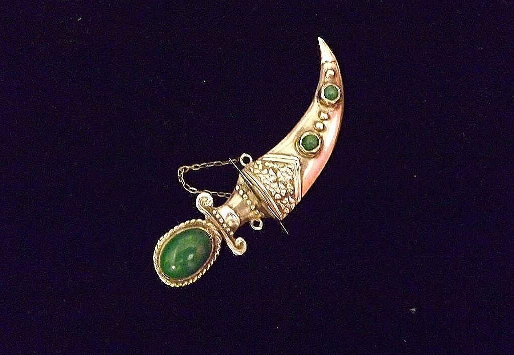 Antique RareMexican Sterling Silver Dagger Brooch/Pin: Mexican Sterling Silver with Jade cabochons dagger in sheath brooch/pin. This superb historic piece features an intricate design in sterling silver and is accentuated by 3 gorgeous deep green Jade cab