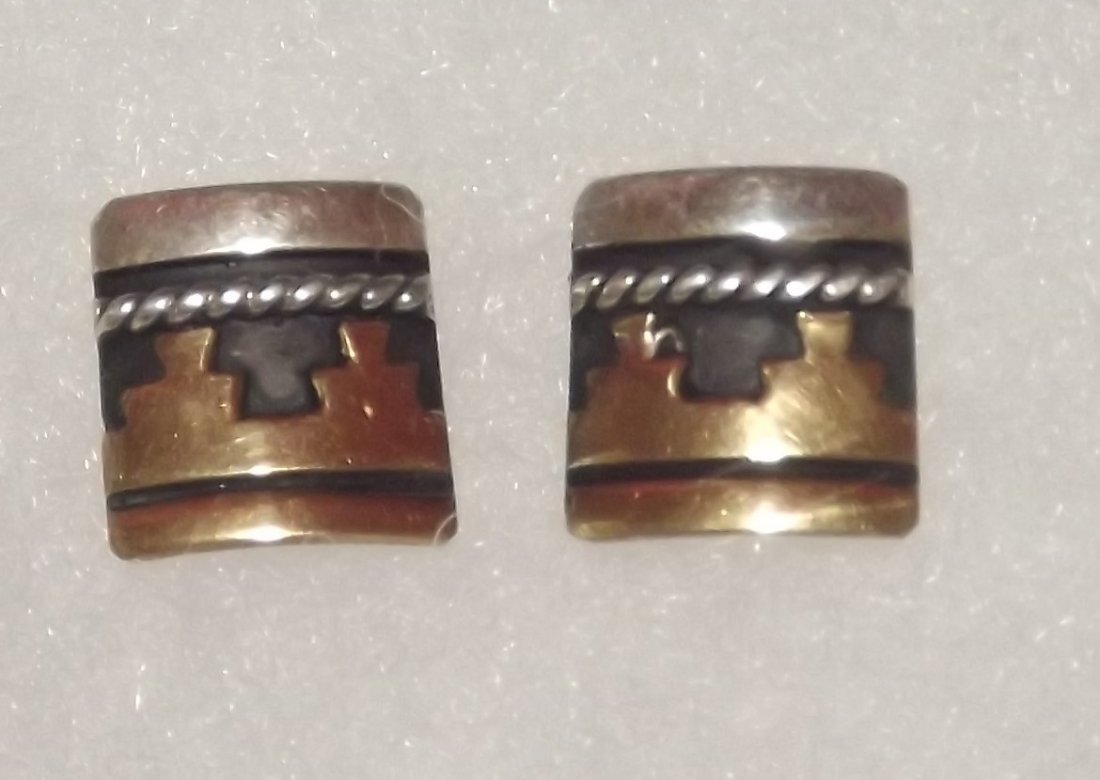 NAVAJO TOMMY SINGER STERLING AND 12K GOLD EARRINGS: Navajo Tommy Singer sterling silver and 12 K Gold overly pierced earrings. Measure about 1/2" wide by 3/4" long. Singed "T.Singer". NO BUYER PREMIUM. EASY IN HOUSE SHIPPING.