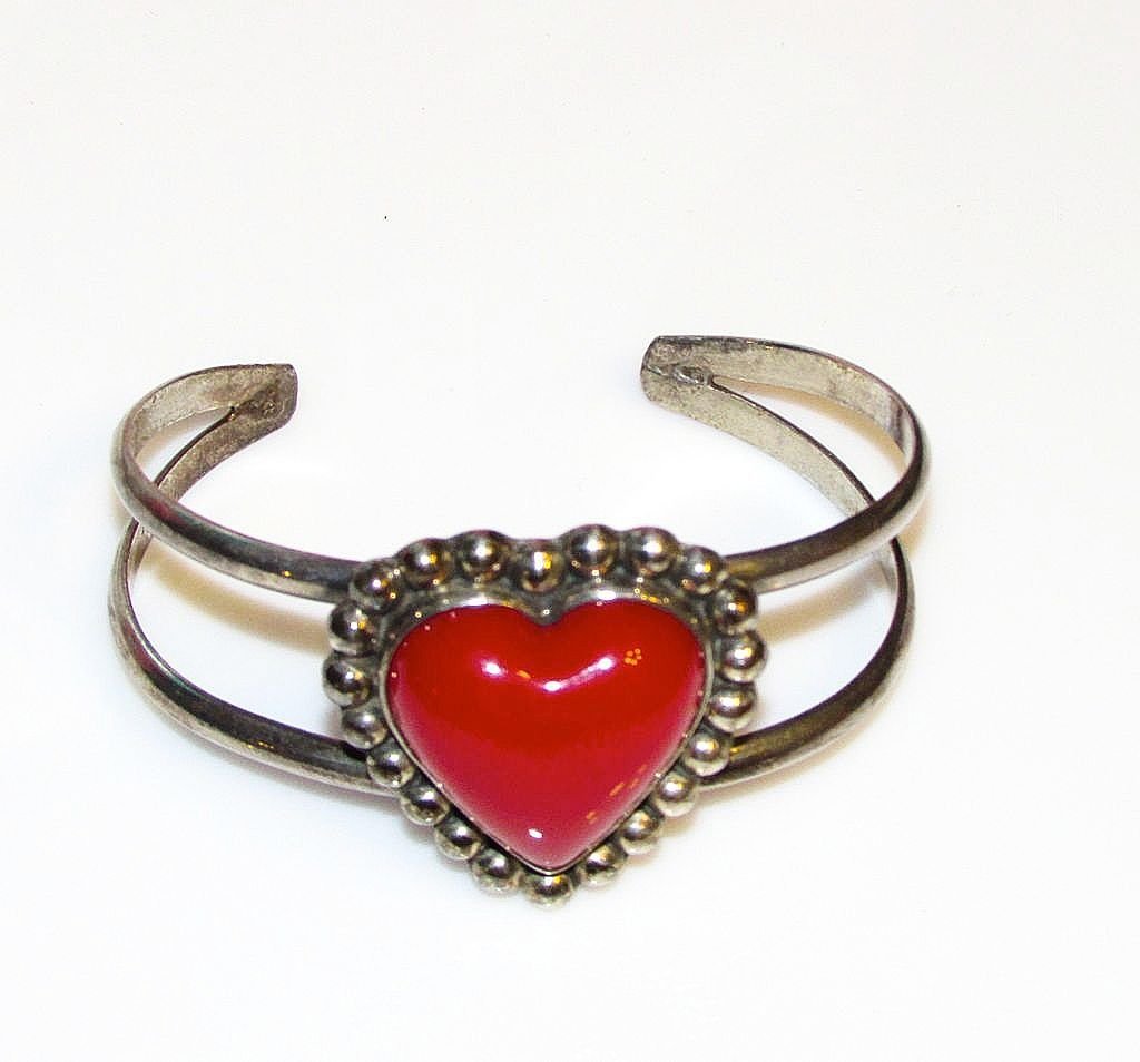 Mexican Taxco 925 Red Enamel Heart Cuff Bracelet: Vintage Taxco heart bracelet in wonderful vintage condition. This gorgeous piece features a unique design in sterling silver accented with a red enamel heart. Marked "Taxco" and stamped "925" and "Mex